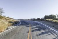 a long road is empty and there are no cars on it in the middle of the road