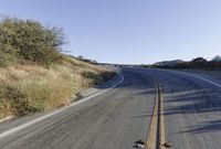 a long road is empty and there are no cars on it in the middle of the road