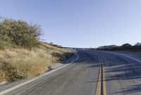 a long road is empty and there are no cars on it in the middle of the road