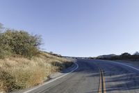 a long road is empty and there are no cars on it in the middle of the road