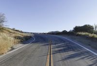 a long road is empty and there are no cars on it in the middle of the road