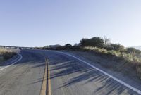 a long road is empty and there are no cars on it in the middle of the road