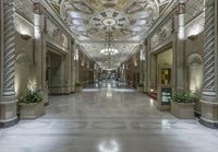 an empty lobby with an intricate ceiling and planters in the middle of it,