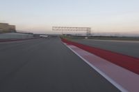 a curve of pavement with the lines painted red and white, as seen from a moving speedboat