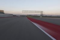 a curve of pavement with the lines painted red and white, as seen from a moving speedboat