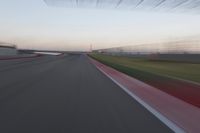 a curve of pavement with the lines painted red and white, as seen from a moving speedboat