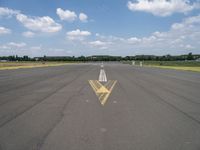 an arrow painted on the runway to indicate how far away you may be coming from it