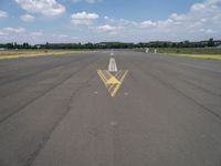 an arrow painted on the runway to indicate how far away you may be coming from it