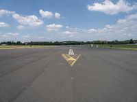 an arrow painted on the runway to indicate how far away you may be coming from it