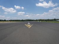 an arrow painted on the runway to indicate how far away you may be coming from it