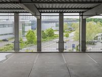 a view of an outdoor courtyard in a building with a lot of tall windows on one side and a street below
