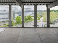 a view of an outdoor courtyard in a building with a lot of tall windows on one side and a street below