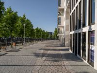 some benches in front of some buildings on the sidewalk with no cars in them but not visible