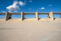 the two bridge are separated by two concrete pillars with an area for vehicles to pass