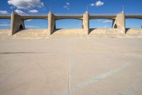 the two bridge are separated by two concrete pillars with an area for vehicles to pass