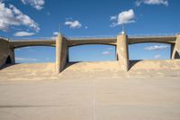 the two bridge are separated by two concrete pillars with an area for vehicles to pass