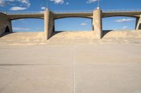 the two bridge are separated by two concrete pillars with an area for vehicles to pass