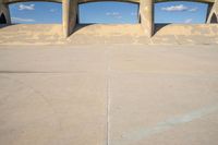 the two bridge are separated by two concrete pillars with an area for vehicles to pass