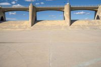 the two bridge are separated by two concrete pillars with an area for vehicles to pass