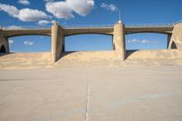 the two bridge are separated by two concrete pillars with an area for vehicles to pass