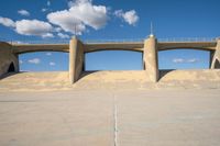 the two bridge are separated by two concrete pillars with an area for vehicles to pass