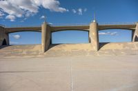 the two bridge are separated by two concrete pillars with an area for vehicles to pass