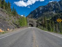 a road goes into a tunnel and through the hill to the other side of it