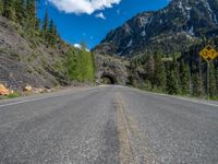 a road goes into a tunnel and through the hill to the other side of it