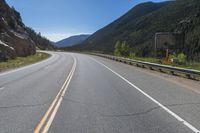 Straight Road Through Colorado Landscape with Mountains