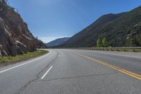 Straight Road Through Colorado Landscape with Mountains