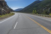 Straight Road Through Colorado Landscape with Mountains