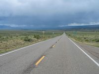 Straight Road Under a Gloomy Grey Sky in Colorado