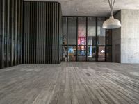 a modern looking lobby with wooden floors and large windows overlooking the city skyline in the day