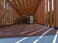 a large long walkway with wooden steps going into an open space outside of the building