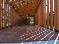 a large long walkway with wooden steps going into an open space outside of the building