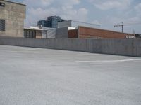 a parking lot and wall are pictured in a photo from the perspective point of view