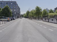 two people are riding on bicycles down the street together in a european city as one man walks