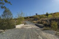 the small wooden bridge crosses a dry creek bed through a rural area in canada that has been turned into a nature preserve