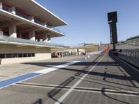 view of track on a sunny day with a bright blue sky overhead and the red track in front of it