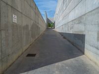 the empty parking lot in front of a wall with apartment buildings on it and a skateboarder on a ramp