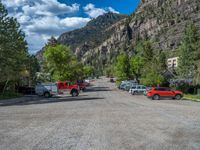 a big house with two fire trucks parked next to it and mountains in the background