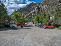 a big house with two fire trucks parked next to it and mountains in the background