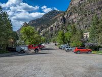 a big house with two fire trucks parked next to it and mountains in the background