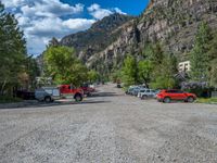 a big house with two fire trucks parked next to it and mountains in the background