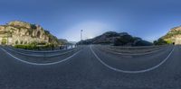 a 360 - ray lens photo of a highway through a fish eye view image of the valley