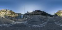 a fish eye view of a street that's made up of rope that surrounds a bridge