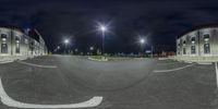 360 - angle picture of a road with a parking lot in the middle and streetlights above