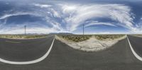 a street in the middle of nowhere with sky in the background and clouds above it