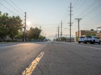 an empty street in front of a large red brick building on the other side of the road is a street light that has a line for motorists