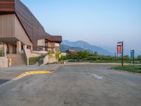 a building that has a bunch of windows on it at sunset with mountains in the background